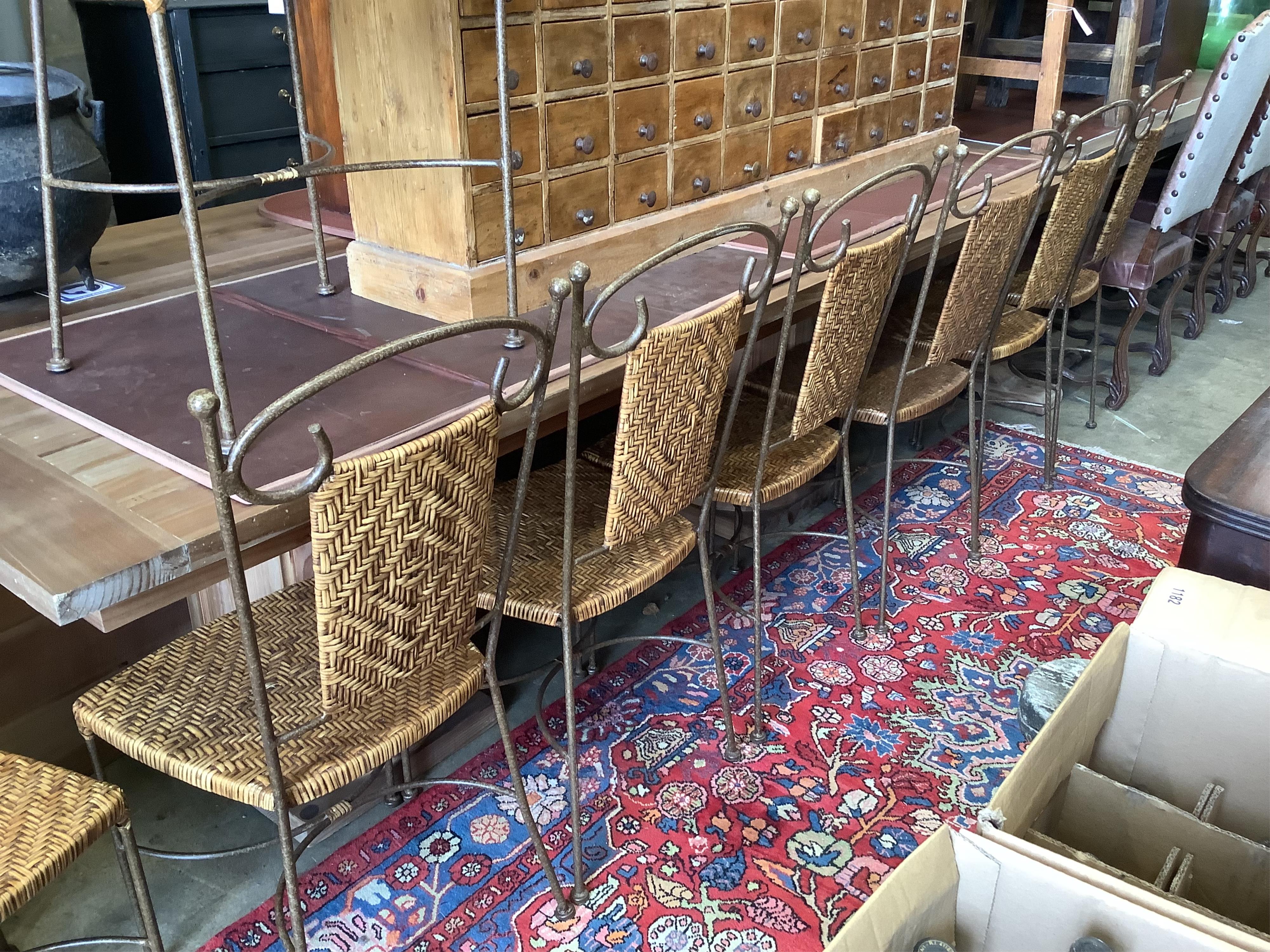 A set of contemporary wrought iron and rattan dining chairs